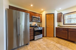 Kitchen - Fully equipped kitchen with refrigerator, range and dishwasher
