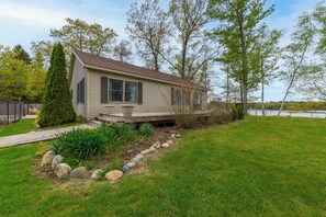 Side Yard & Deck - Yard and Deck that runs along the side of the house and is accessible through Siding Doors