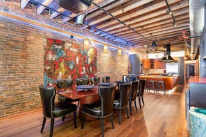 Unit 2: Dining area with seating for 10 guests and a bar with an ice maker and wine cooler.