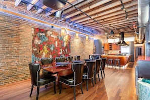 Unit 2: Dining area with seating for 10 guests and a bar with an ice maker and wine cooler.