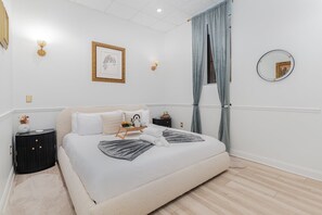 Unit 1: Primary Bedroom featuring a King Bed, Smart TV, and a wardrobe.