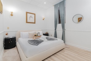 Unit 1: Primary Bedroom featuring a King Bed, Smart TV, and a wardrobe.