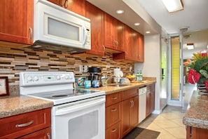 MKV-C152 This charming kitchen mixes rich cherry cabinets, a mosaic backsplash, and countertop cheer that?s ready to serve joy