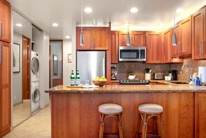 PKC-403 This inviting space pairs a cozy sectional and sleek kitchen with nautical art and breezy loft vibes for relaxed elegance