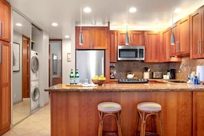 PKC-403 This inviting space pairs a cozy sectional and sleek kitchen with nautical art and breezy loft vibes for relaxed elegance