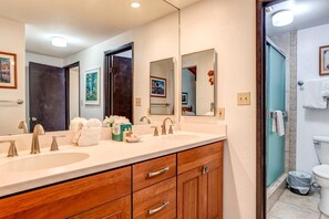 NAP-C42 Framed art, warm wood cabinetry, and light-filled sightlines make this guest bath feel both inviting and tastefully styled