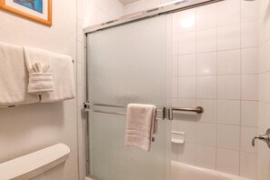 NAP-C42 Enclosed in frosted glass and lined with glossy white tile, this inviting shower offers a refreshing escape in clean simplicity