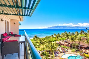 HKH-603 Oceanfront balcony views, lush palms, vibrant poolside, island serenity.