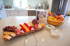 Welcome charcuterie board & bowl of fruits, chips & cereal