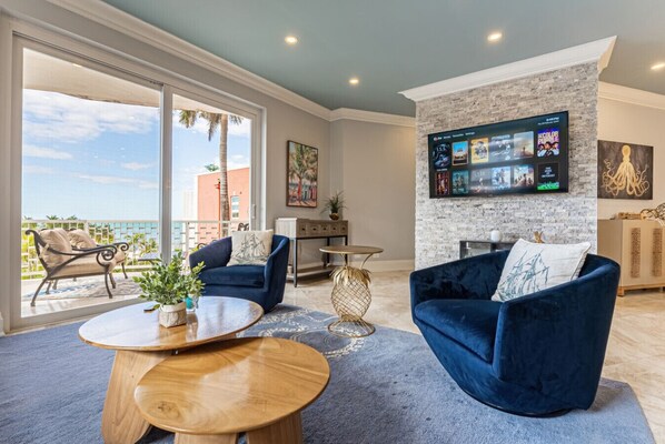 Living room w/ ample seating, smart TV, Apple HomePods & ocean view walkout balcony!