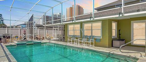 Huge heated pool + spa under screened lanai to spend your day