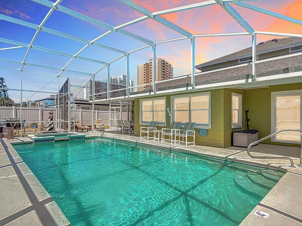 Huge heated pool + spa under screened lanai to spend your day