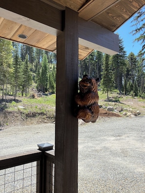 Porch wood-carved bear greets your arrival.