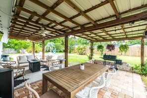 Relax by the firepit, watch TV, dine under string lights, and enjoy cold drinks from the mini fridge in this fully equipped backyard oasis.