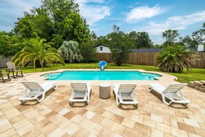 Your private tropical escape — soak up the sun on luxe loungers, surrounded by swaying palms and a sparkling pool just steps from the door