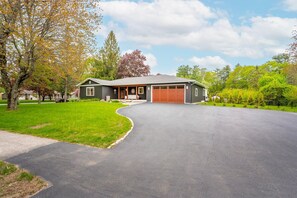 A beautiful, well-maintained home nestled in a lush, green landscape.