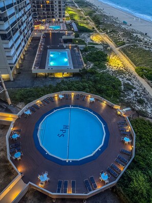 Pool and beach view at sunset