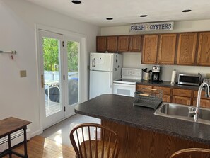 Full, equipped kitchen with outdoor grill. 