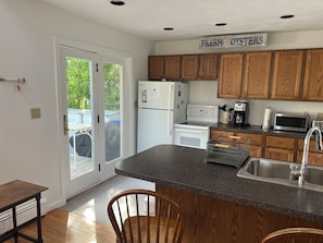 Full, equipped kitchen with outdoor grill.