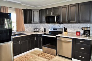Full kitchen with fridge, dishwasher, stove, oven, microwave, coffee pot, etc.