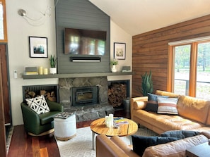 Cozy living room, new leather sectional, Smart TV, Sonos surround sound, games.