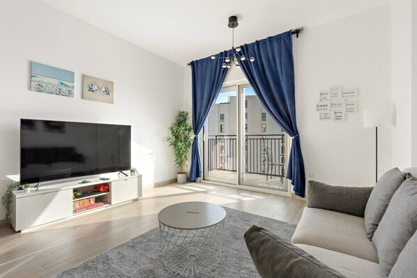 Living Room: Bright space with modern decor, perfect for relaxing or entertaining! Enjoy the view!
