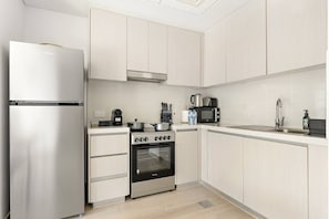Modern Kitchen: Sleek appliances and ample space make meal prep a delight in this stylish kitchen!