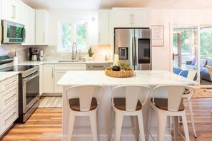 Sleek modern kitchen with smart fridge and countertop seating at the island bar. This is the heart of the home!