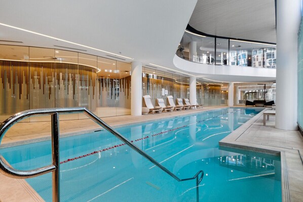 Shared heated indoor pool area with gym seen up top.