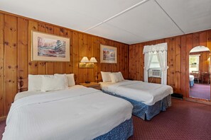Spacious Double Queen Room with classic wood paneling, natural light, and everything you need for a comfortable and convenient stay