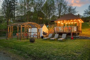 As the sun sets, the shared outdoor space becomes even more magical with cozy lighting and peaceful vibes.