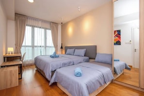 The bedroom with a queen sized bed & a single sized floor matress.