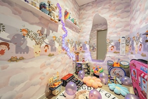 Bright and cheerful kid’s playroom filled with fun toys and safe space.
