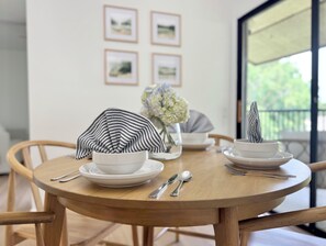 Dining for 4 with modern dishware, silverware and natural lighting.