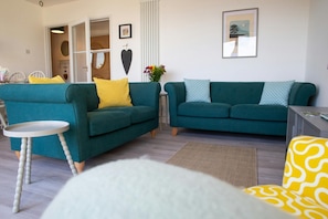 Sitting room with two two seater sofa and occasional table