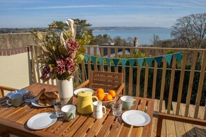 Balcony with table and chairs and sea views