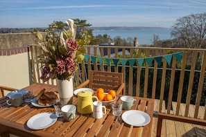 Balcony with table and chairs and sea views