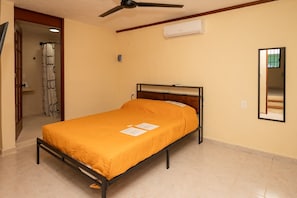 Queen Bed with Window and Blackout Curtains
Designed for deep rest — natural light and garden view by day, blackout privacy by night.