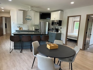 Upstairs common area with island and table 
