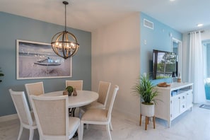 Cozy dining nook with a round table and cushioned chairs.