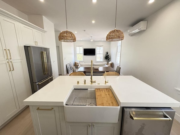 Central island with farmhouse sink, perfect for prepping meals or casual dining.