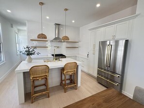 Sleek, fully equipped kitchen with stainless steel appliances and ample counter space.