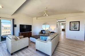 Spacious living room with large TV.
