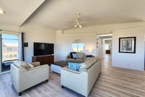 Spacious living room with large TV.