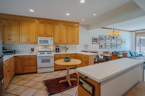 Whip up family favorites in the stocked kitchen with tons of space to chop, stir, and serve