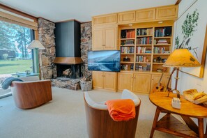 Open and inviting living room with a real wood-burning fireplace—ideal for movie nights and snow days