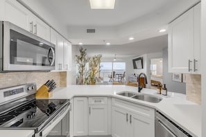 Cook in the updated kitchen with stainless steel appliances and a stunning ocean view