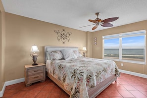 Wake up to endless ocean views in the direct oceanfront master bedroom featuring a king bed, ensuite bath, and TV