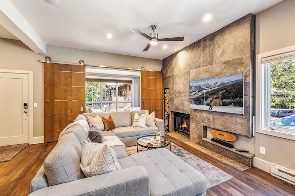 Living room: Main floor, Wood-burning fireplace, Smart TV, L-sectional, dining table