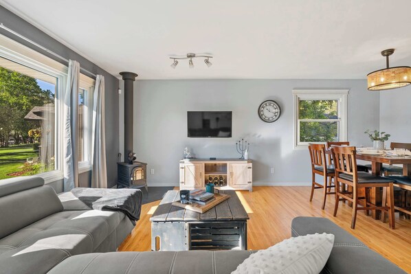 Spacious living room with cozy vibes and sunlight pouring in.